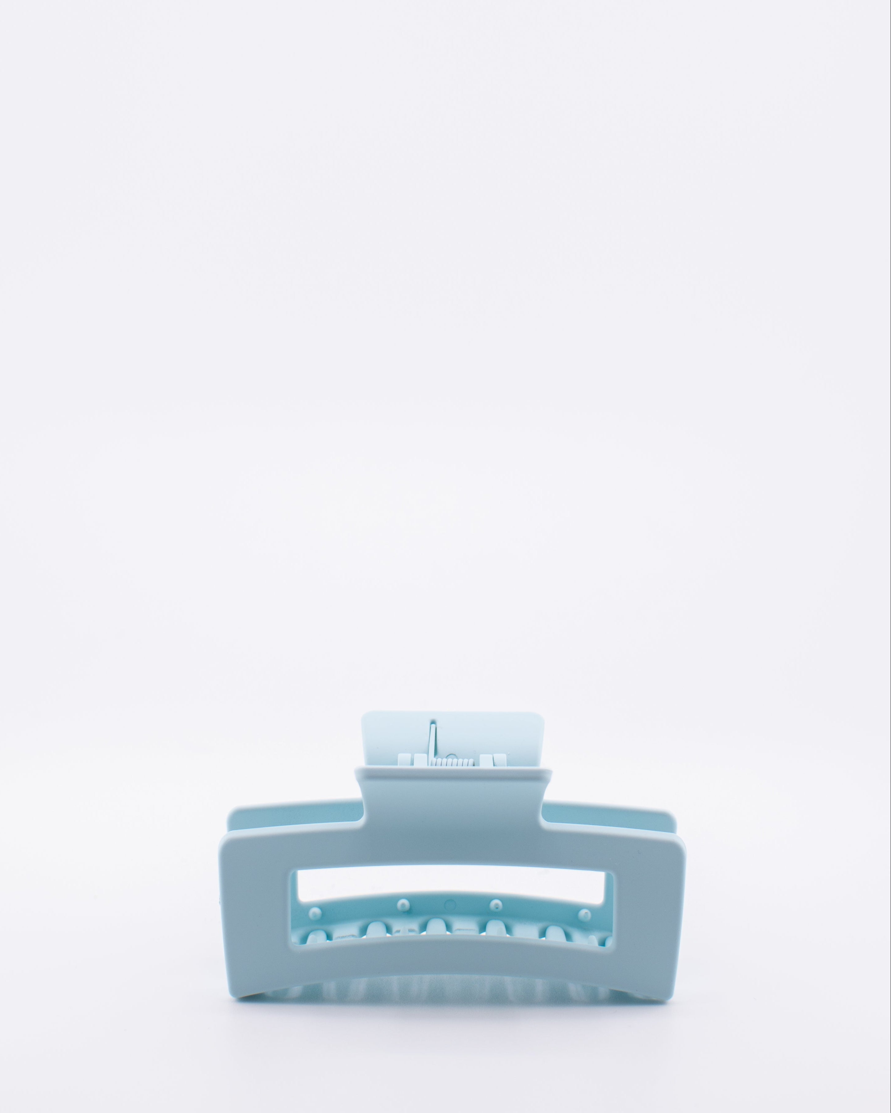 Light blue hair clip on a white background