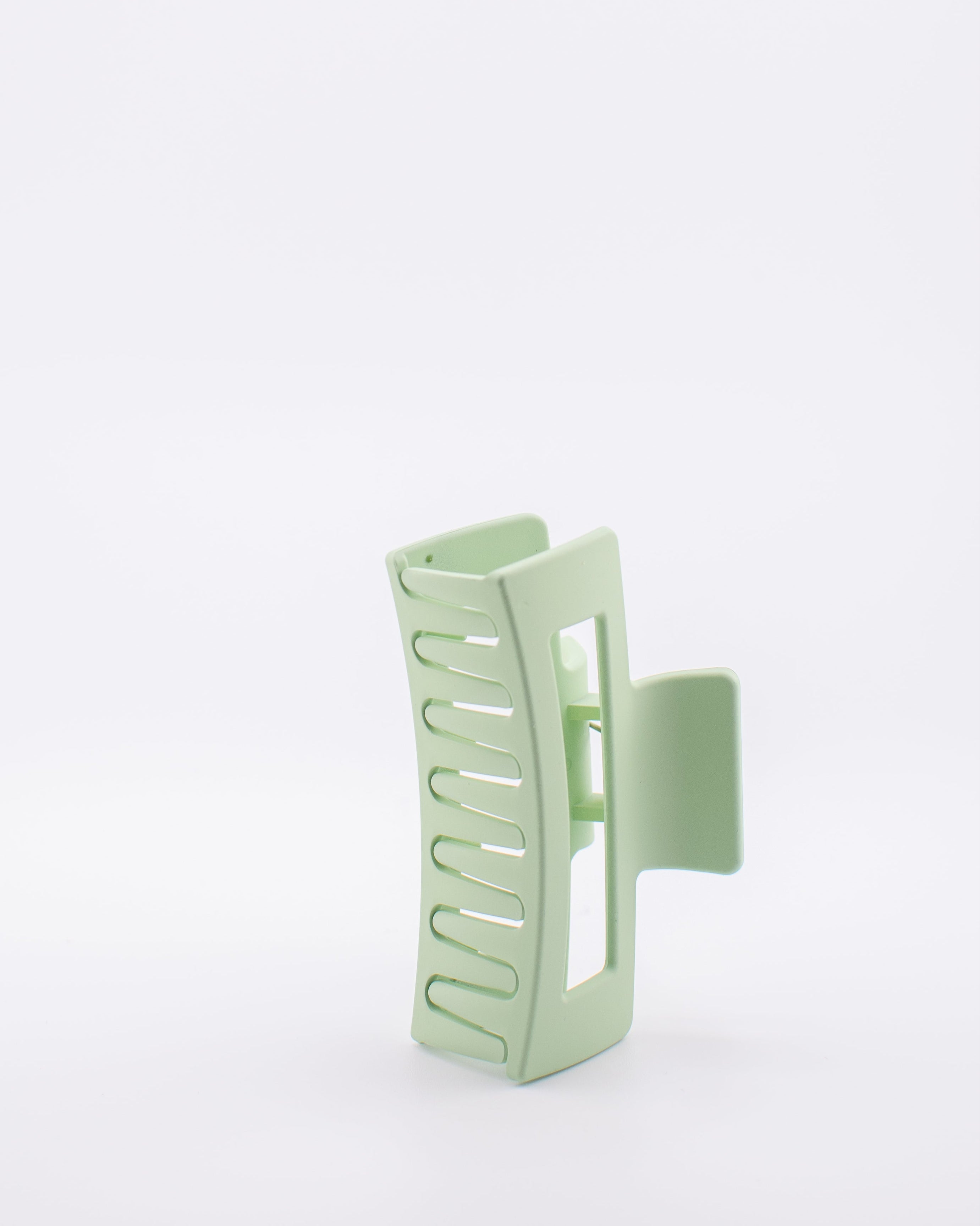 Light green hair clip on a white background