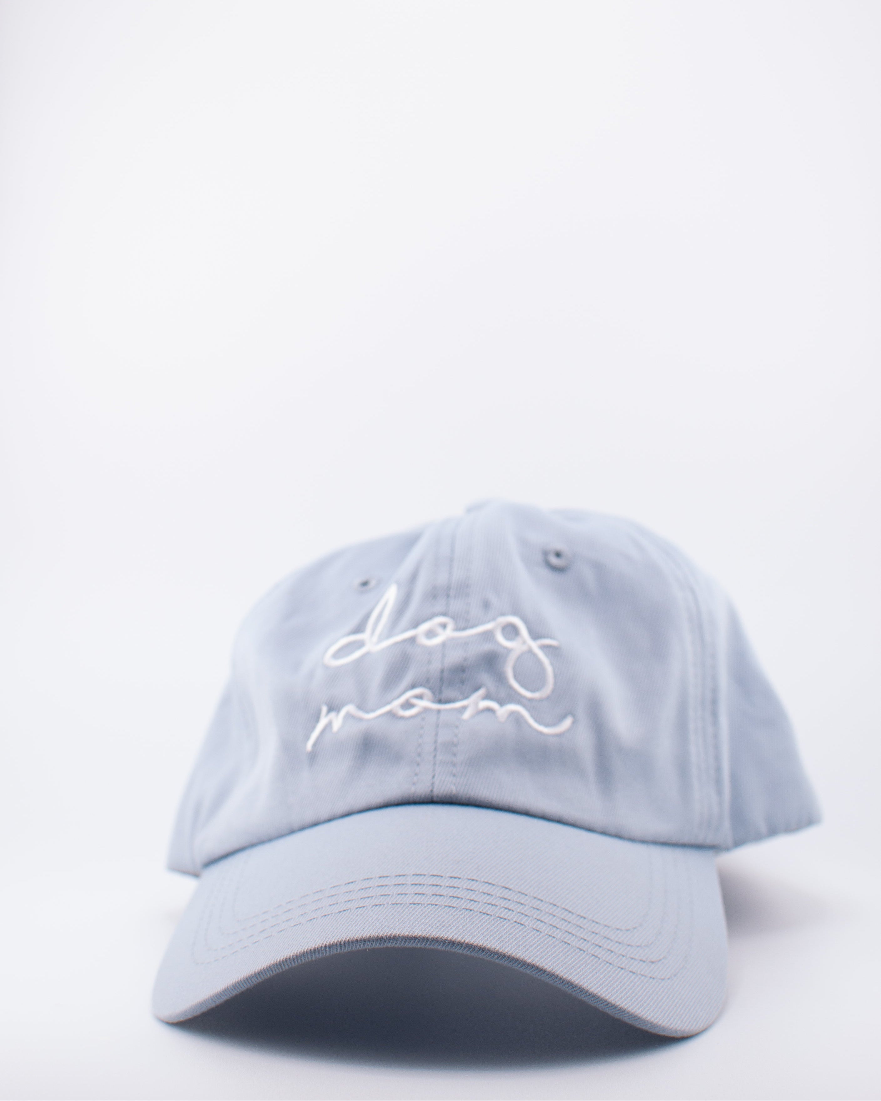 Light blue cap with 'dog mom' embroidery on a white background