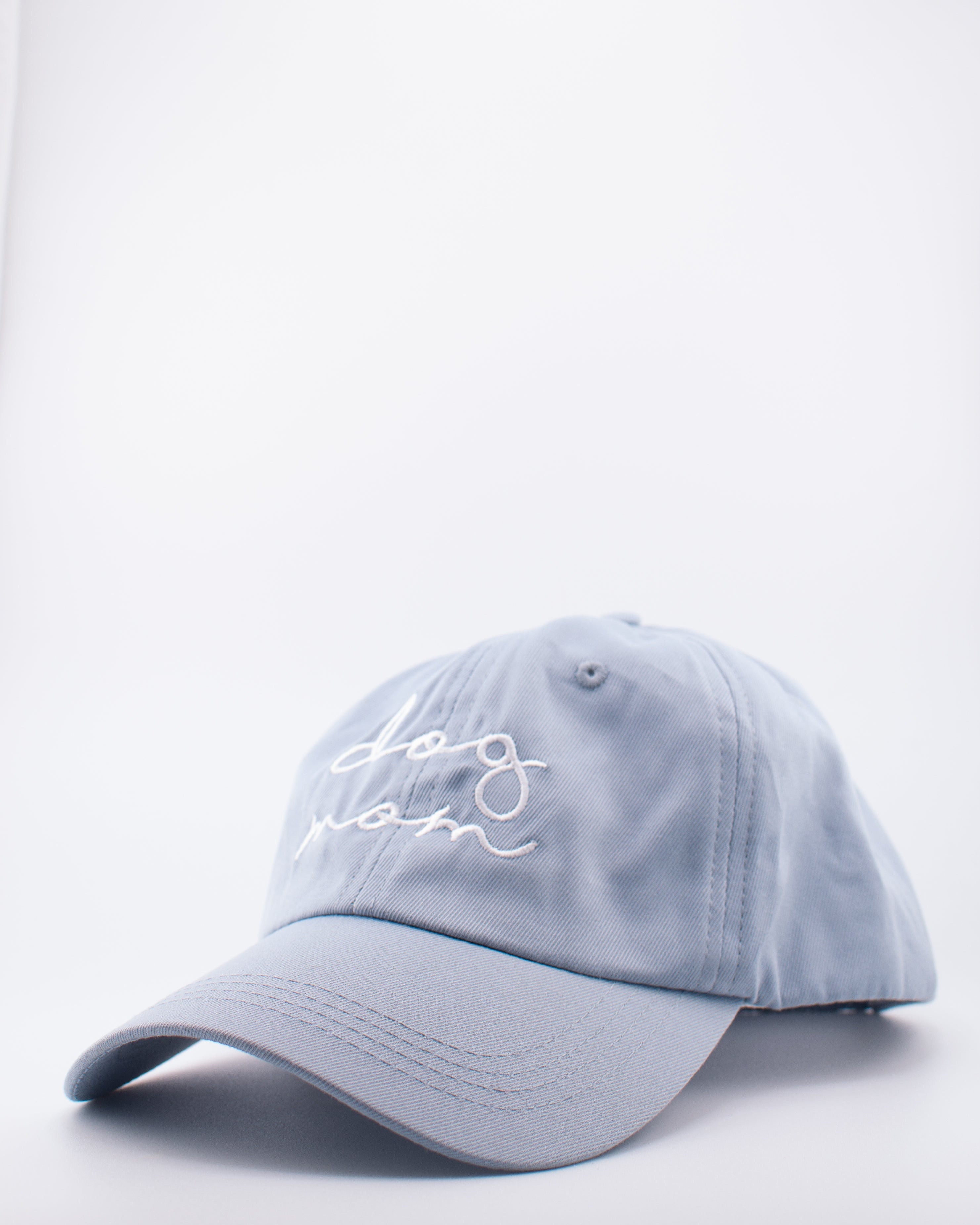 Light blue cap with 'dog mom' embroidery on a white background